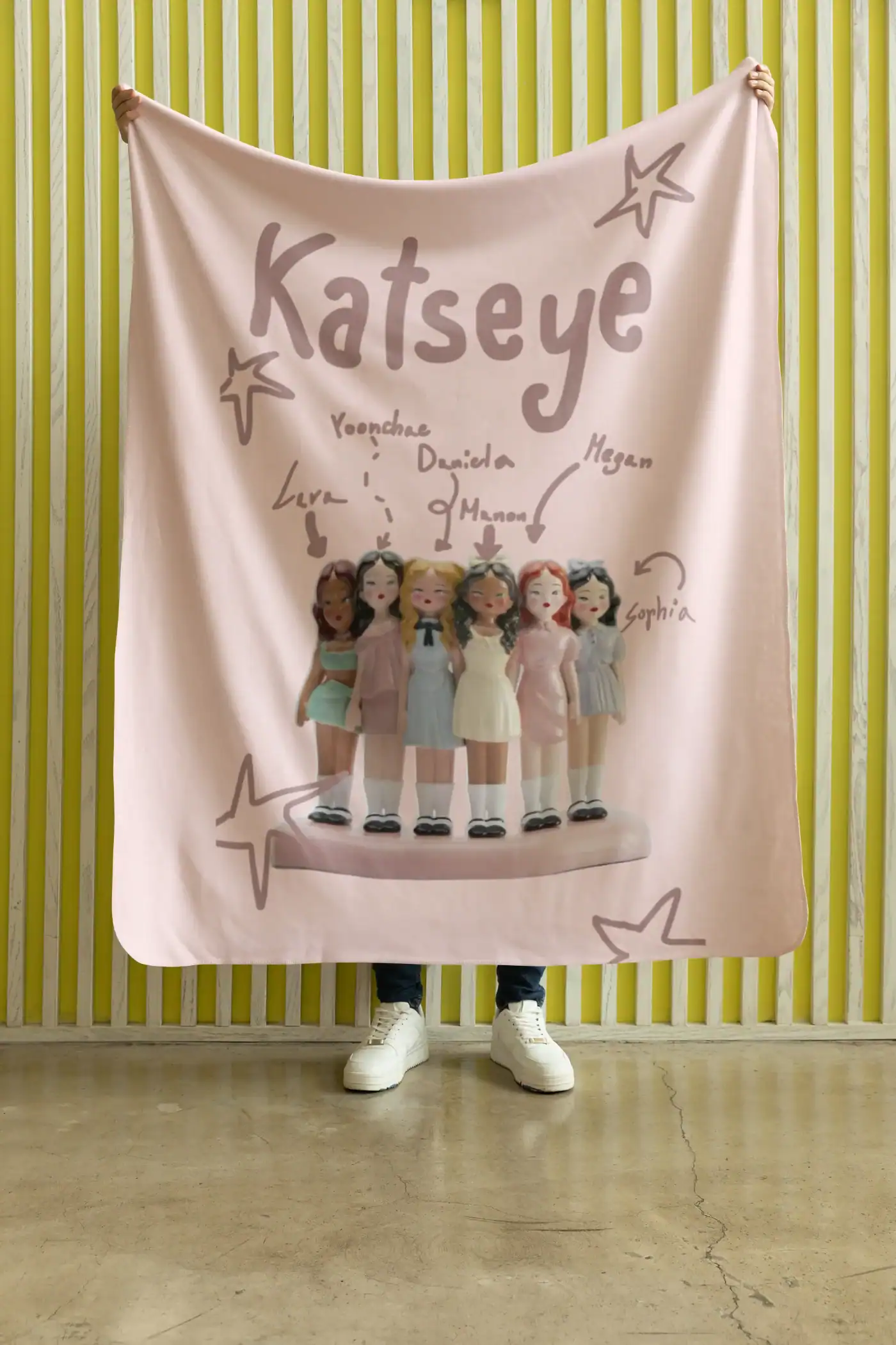model holding katseye blanket
