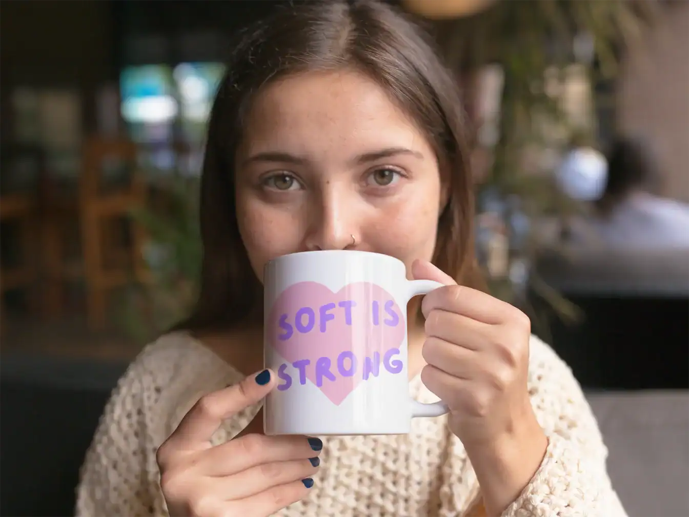 hazel eyes model drinking coffee from white ceramic katseye mug