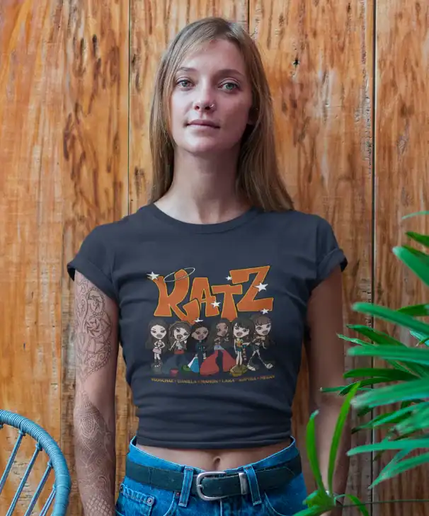 model wearing blue katseye katz t-shirt made of 100% cotton with wood wall behind