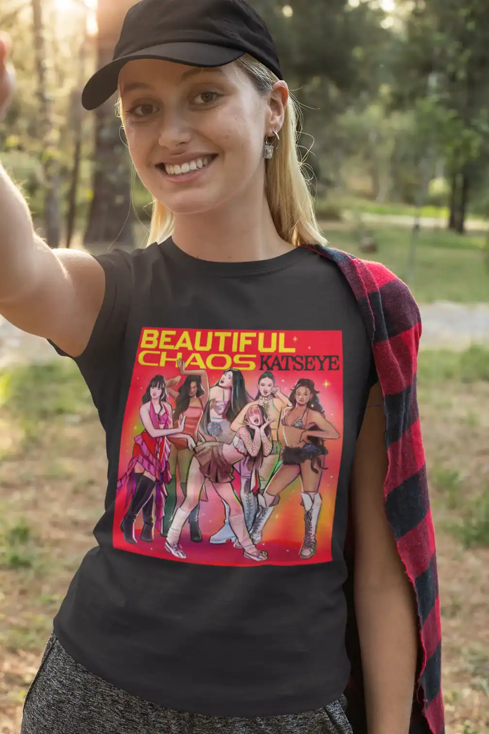 blonde girl wearing black katseye tshirt made of cotton