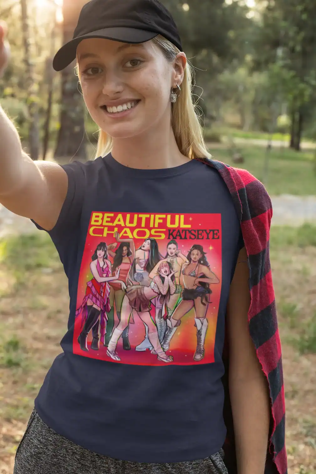 blonde girl wearing blue katseye t-shirt with beautiful chaos design