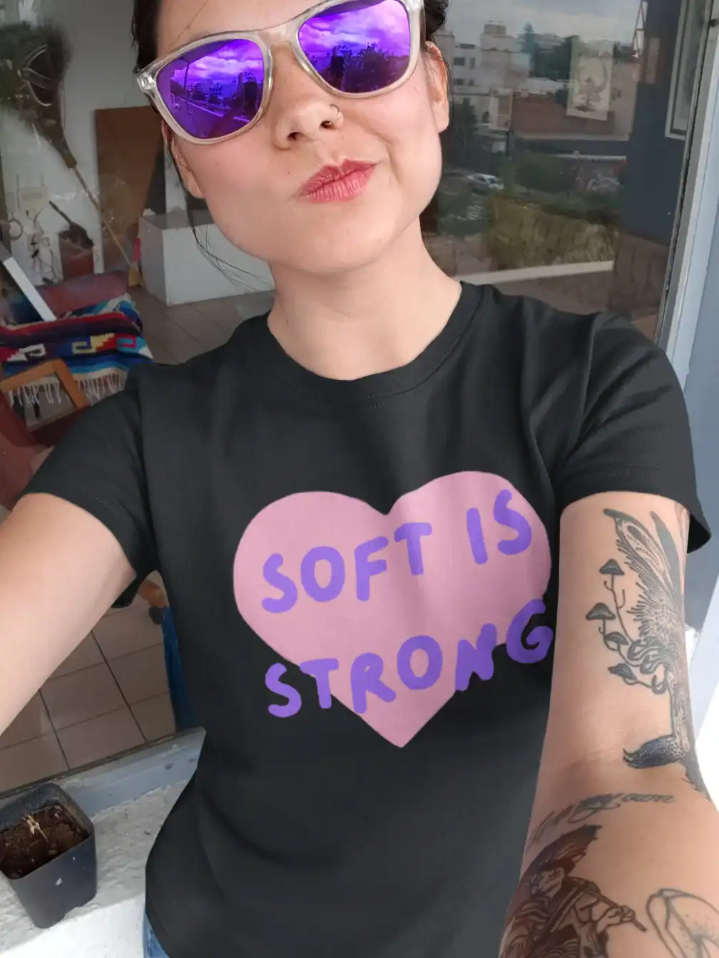 tatooed girl with sunglasses wearing katseye soft is strong black t-shirt authentic
