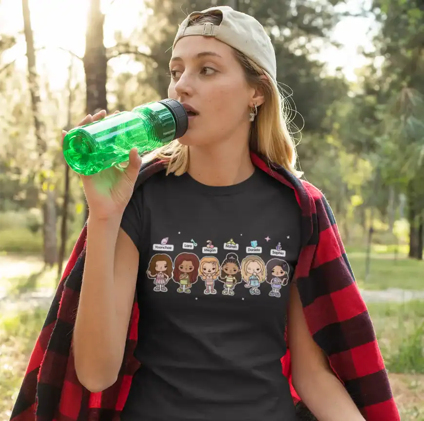 pretty girl wearing black katseye x toca boca t-shirt while drinking water from green bottle